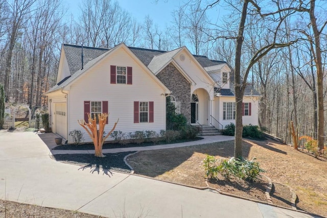 view of front of home featuring stone siding and concrete driveway