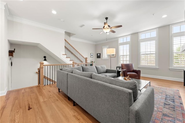 living room with crown molding, baseboards, light wood-type flooring, recessed lighting, and a ceiling fan