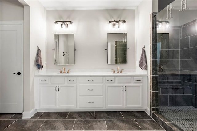 full bath featuring a sink, tiled shower, double vanity, and tile patterned flooring