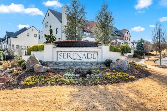 community / neighborhood sign with a residential view