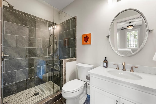 bathroom with toilet, a stall shower, and vanity