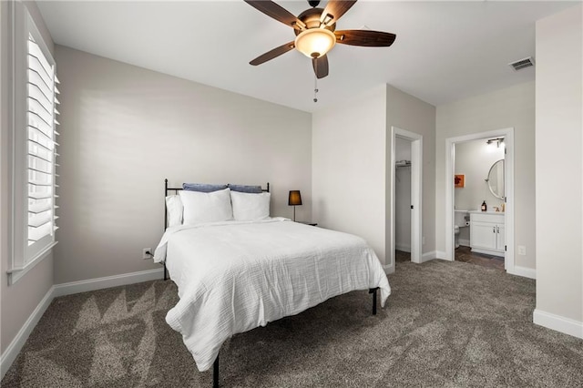 carpeted bedroom with visible vents, ceiling fan, connected bathroom, and baseboards