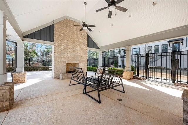 view of patio / terrace featuring fence, a ceiling fan, and an outdoor brick fireplace