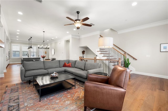 living area with recessed lighting, stairs, baseboards, and wood finished floors