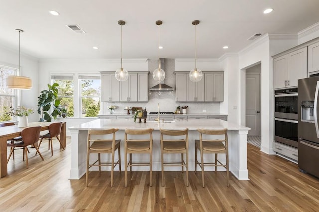 828 Chestnut Pl, Milton, GA 30004 - kitchen with wall chimney exhaust hood, gray cabinetry, appliances with stainless steel finishes, ornamental molding, and light countertops