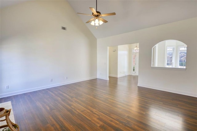 empty room with visible vents, baseboards, dark wood-style floors, high vaulted ceiling, and a ceiling fan