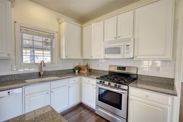 kitchen featuring a sink, dark wood finished floors, white appliances, white cabinets, and decorative backsplash