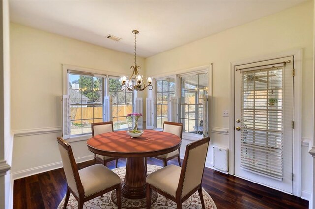 dining room with visible vents, baseboards, a chandelier, and dark wood-style flooring