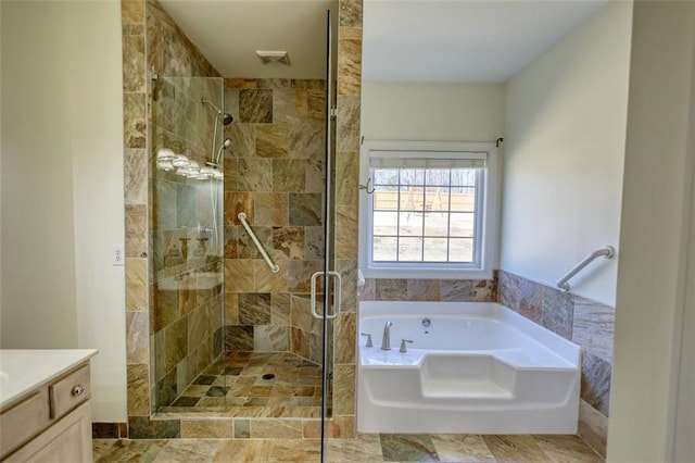 bathroom with a bath, visible vents, a stall shower, and vanity