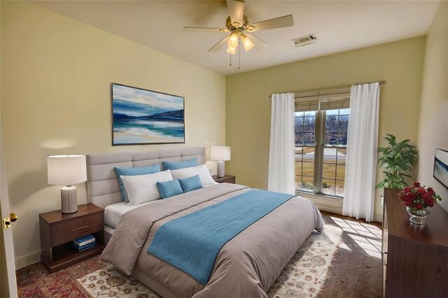 carpeted bedroom featuring visible vents, baseboards, and ceiling fan