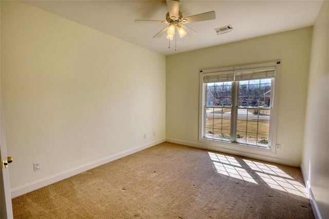 unfurnished room featuring a ceiling fan, carpet flooring, visible vents, and baseboards