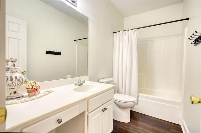 full bath featuring toilet, vanity, shower / tub combo, and wood finished floors