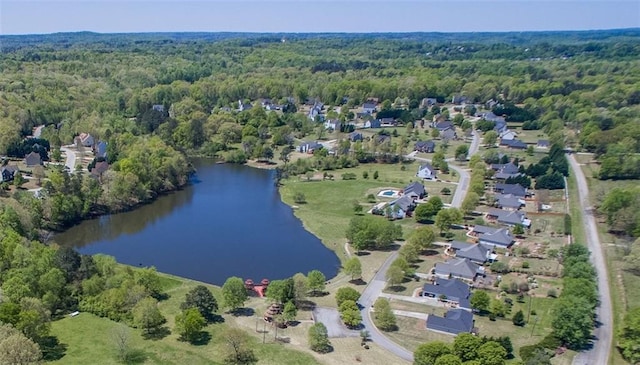 drone / aerial view with a water view and a wooded view