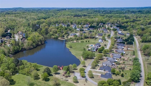 bird's eye view featuring a view of trees and a water view