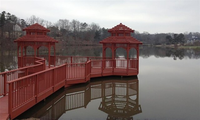 dock area with a gazebo and a water view