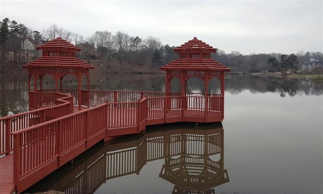 view of dock featuring a gazebo and a water view