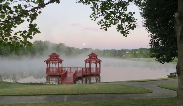 dock area featuring a gazebo, a yard, and a water view