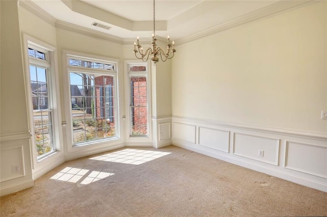 unfurnished dining area with a tray ceiling, light colored carpet, visible vents, and a chandelier