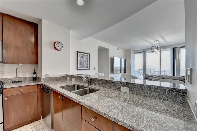 kitchen with light stone countertops, kitchen peninsula, sink, dishwasher, and light tile patterned flooring