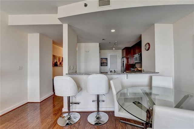 dining room with dark wood-type flooring