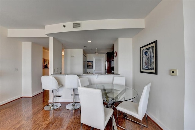 dining area featuring wood-type flooring