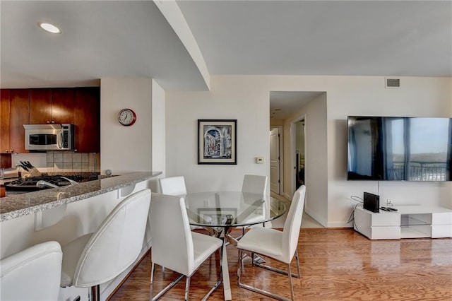 dining space featuring light hardwood / wood-style floors