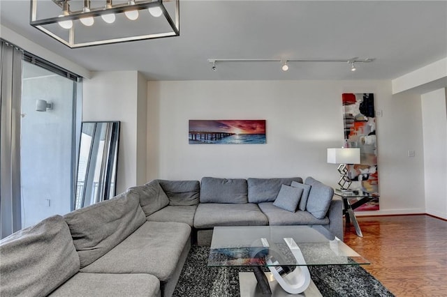 living room with track lighting and hardwood / wood-style flooring