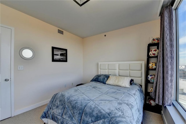 carpeted bedroom with multiple windows