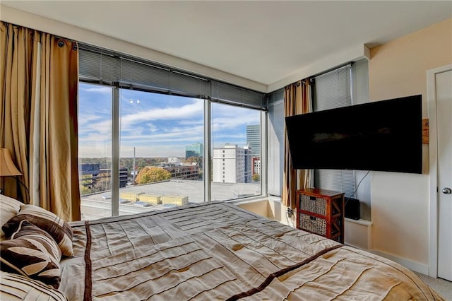 carpeted bedroom featuring access to outside and multiple windows