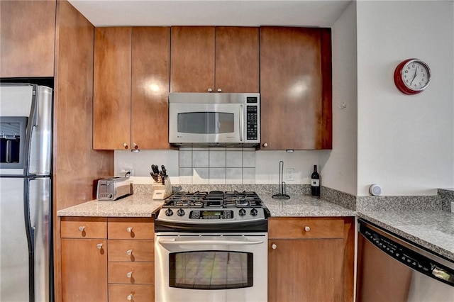 kitchen featuring light stone countertops and appliances with stainless steel finishes