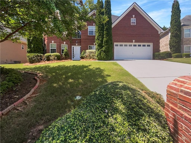 view of front of home with a front lawn and a garage