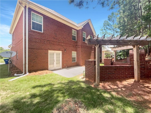 rear view of property featuring french doors, a pergola, a patio area, and a yard