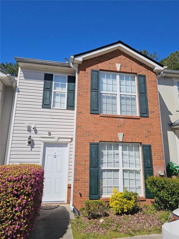 view of front of home featuring brick siding