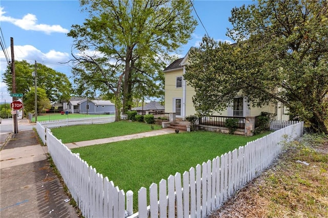 view of front of property with a fenced front yard and a front lawn