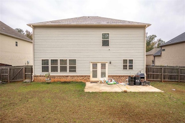 back of property with a patio area and a lawn