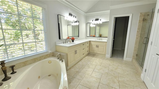 bathroom with vanity, shower with separate bathtub, and vaulted ceiling