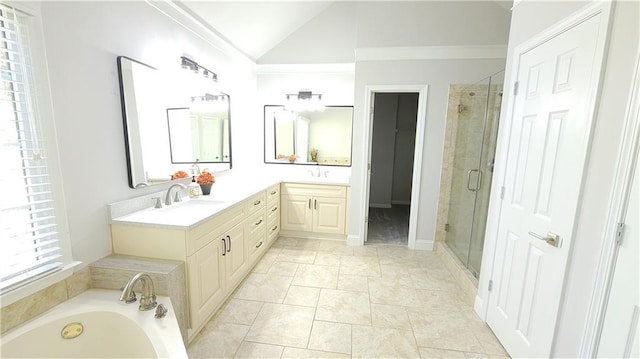 bathroom featuring vanity, a shower with door, and vaulted ceiling