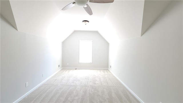 additional living space with ceiling fan, light colored carpet, and vaulted ceiling