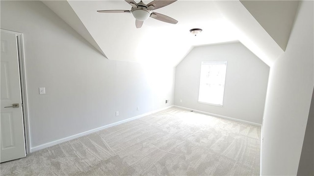 bonus room with vaulted ceiling, light colored carpet, and ceiling fan