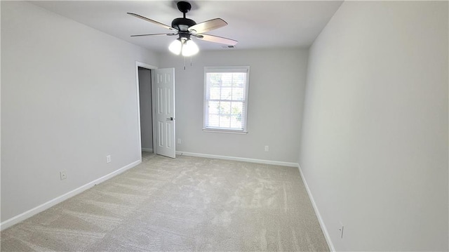 carpeted spare room with ceiling fan