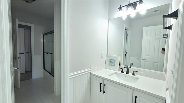 bathroom featuring walk in shower and vanity