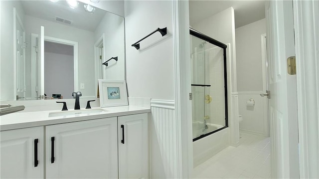 bathroom with vanity and shower / bath combination with glass door