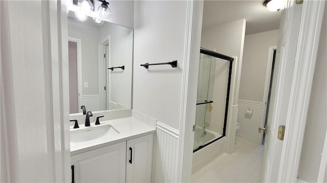 full bathroom with toilet, vanity, shower / bath combination with glass door, and tile patterned flooring