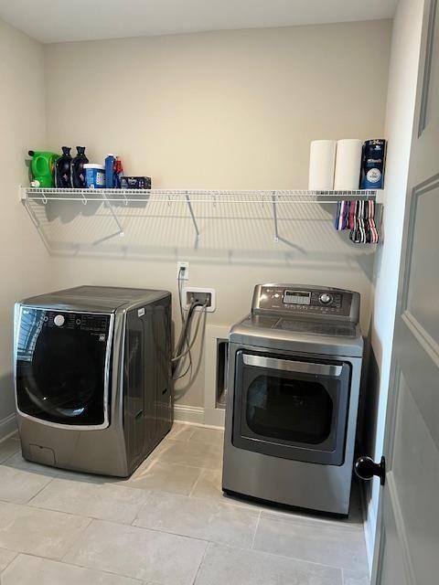 224 Crest Creek Way, Villa Rica, GA 30180 - laundry area featuring washer and clothes dryer and light tile patterned floors