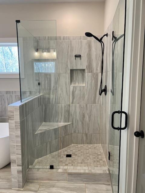 224 Crest Creek Way, Villa Rica, GA 30180 - full bath featuring a shower stall, a freestanding bath, and tile walls
