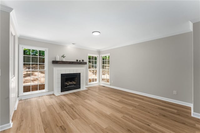 4816 Morning Chase NW, Acworth, GA 30102 - unfurnished living room with ornamental molding, light wood-style floors, and a tile fireplace