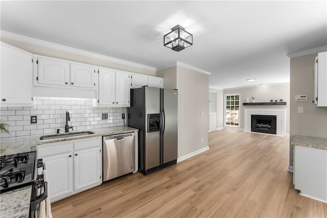 4816 Morning Chase NW, Acworth, GA 30102 - kitchen with appliances with stainless steel finishes, white cabinetry, tasteful backsplash, light wood-type flooring, and crown molding