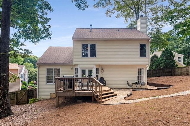 4816 Morning Chase NW, Acworth, GA 30102 - back of property with a fenced backyard, a deck, a chimney, and a shingled roof