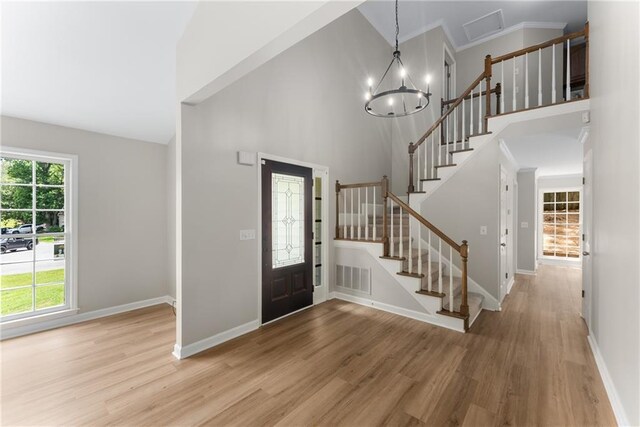 4816 Morning Chase NW, Acworth, GA 30102 - entrance foyer featuring high vaulted ceiling, a chandelier, wood finished floors, and stairway