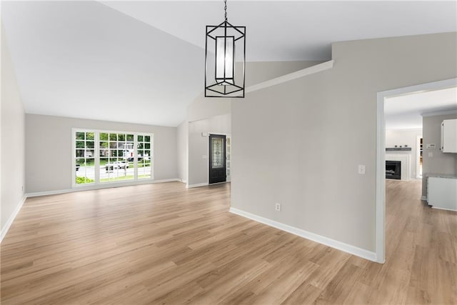 4816 Morning Chase NW, Acworth, GA 30102 - unfurnished living room featuring lofted ceiling, light wood-type flooring, and a fireplace